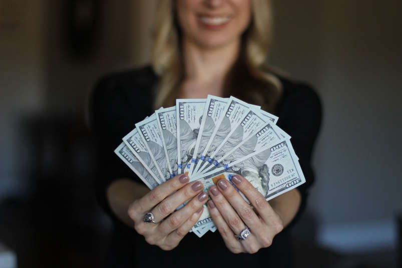 Woman Holding Cash; sallyjermain/Pixabay