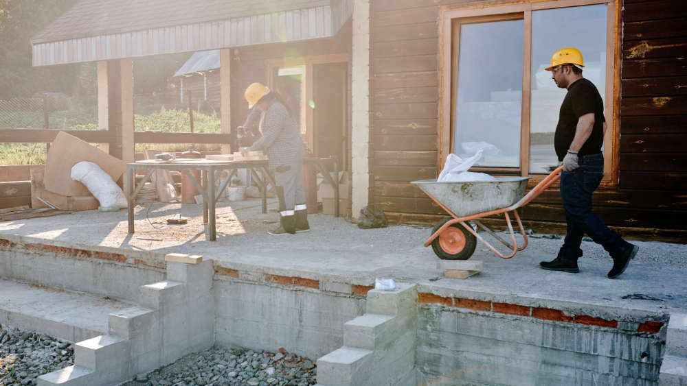 Two builders at a house
