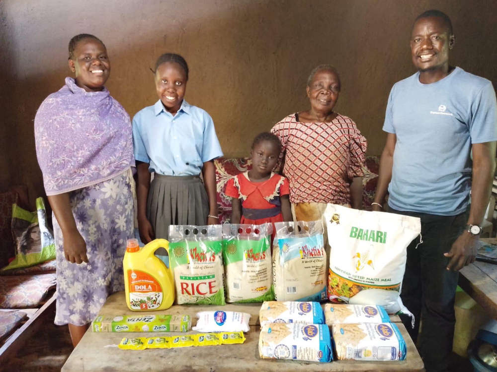 A family receiving food from Orphan Outreach