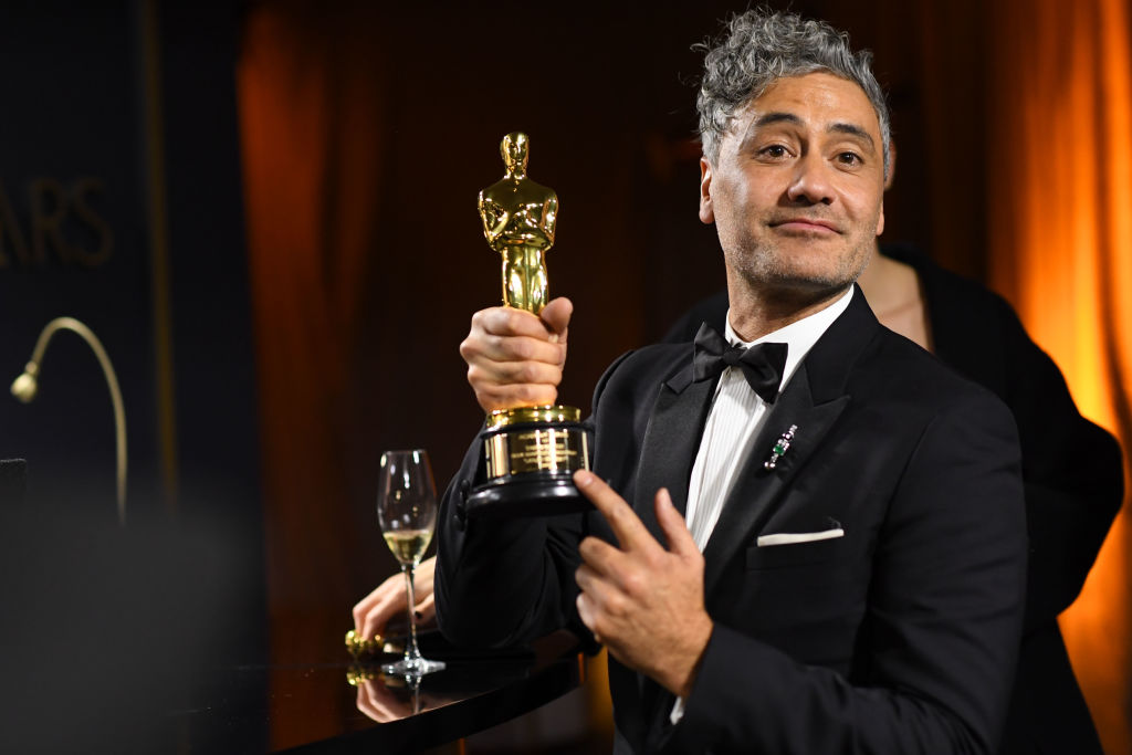 Taika Waititi poses with his Oscar for Adapted Screenplay