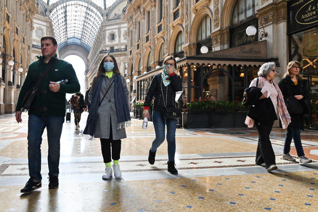 People wearing a protective facemasks at the Gallery Vittorio Emanuele II, in central Milan, amid the Coronavirus outbreak