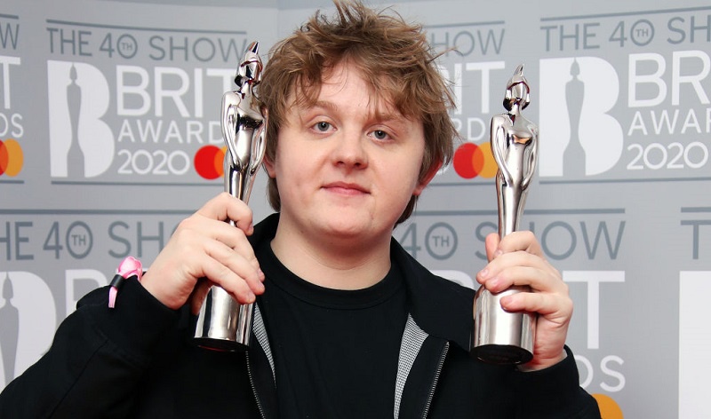 Lewis Capldi holding two Brit Awards