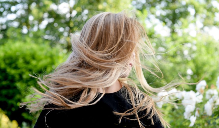 Girl with blonde hair blowing in the wind