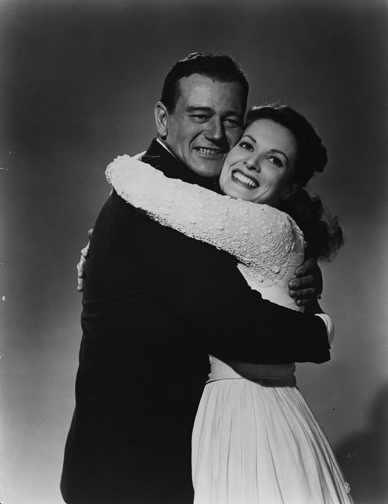 John Wayne and Maureen O'Hara embrace in a publicity still for 'The Quiet Man'. 