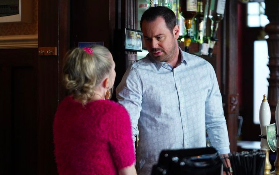 A scene from EastEnders featuring Mick Carter and Linda Carter behind the bar at the Queen Vic