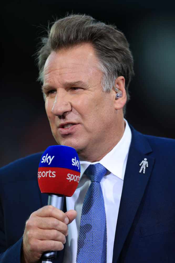Paul Merson appearing on Football television, holding a Sky Sport microphone