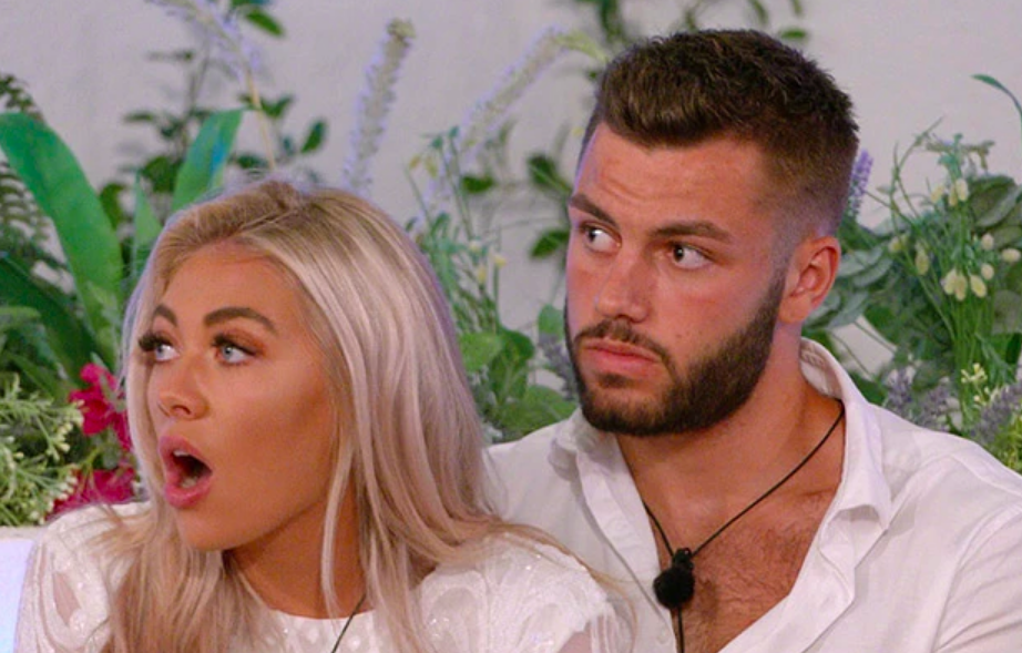 A scene from the most recent series of Love Island, featuring winners Paige Turley and Finn Tapp