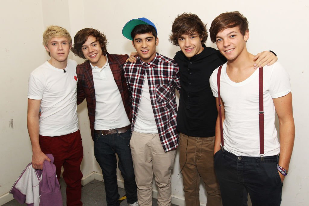 One Direction pictured with arms around each other in 2011, with Zayn Malik standing in the centre of the group.