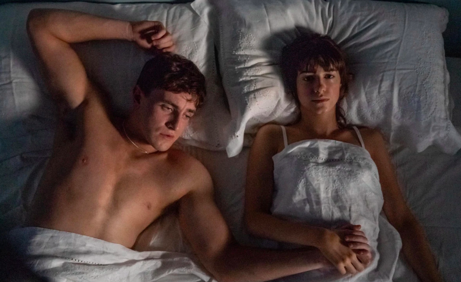 Normal People characters Marianne and Connell lie side by side in bed