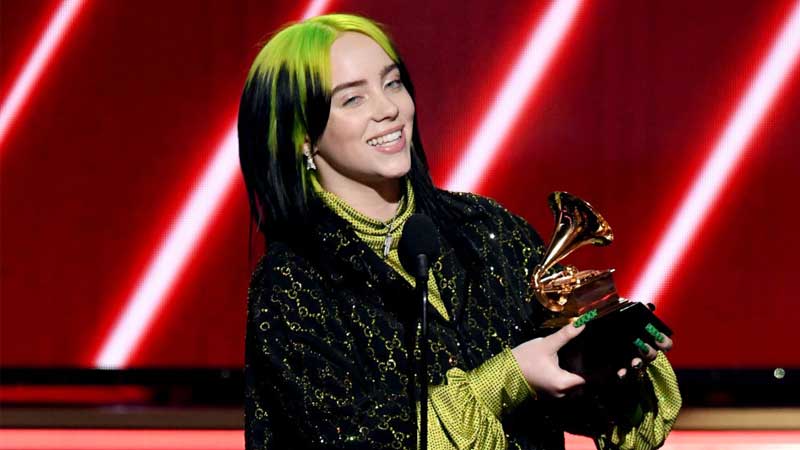 Billie Eilish holding her Grammy