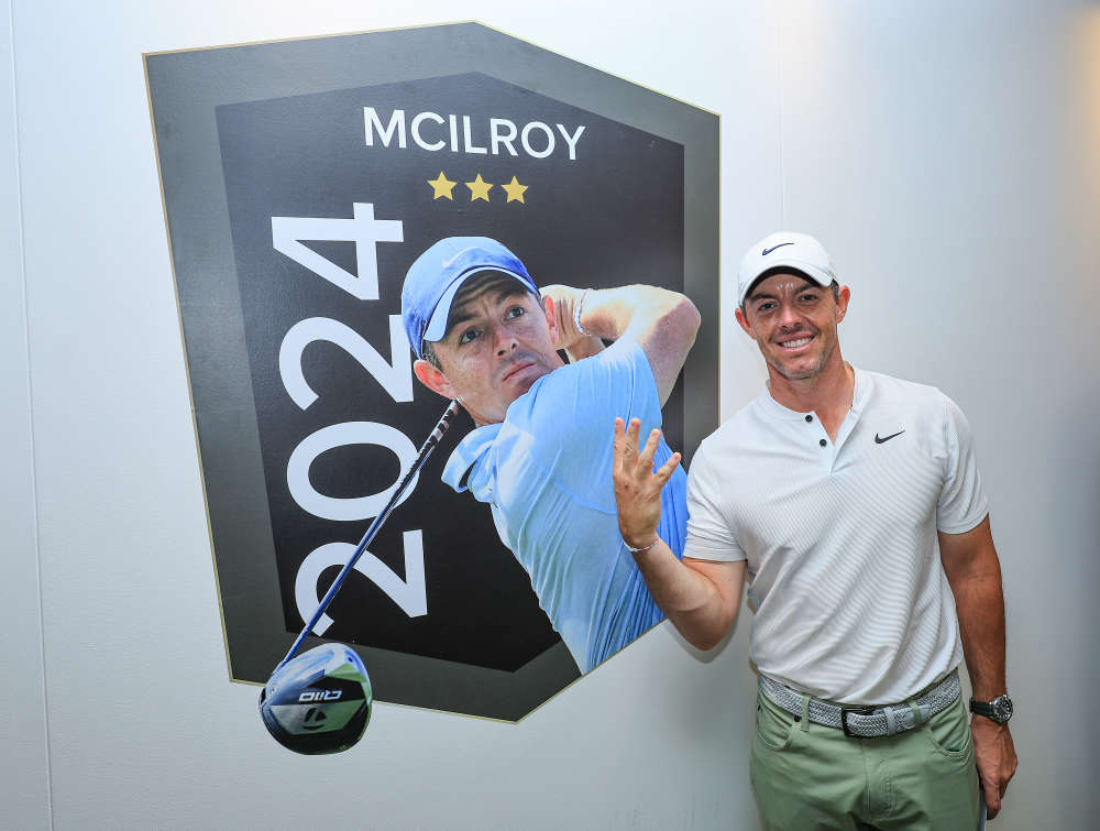 Rory McIlroy poses beside a picture of himself following his fourth win at the Hero Dubai Desert Classic (Photo by David Cannon/Getty Images)