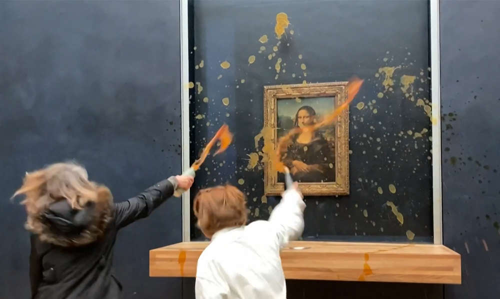 Protestors throwing soup over the Mona Lisa in the Louvre Museum in Paris (Photo by DAVID CANTINIAUX/AFPTV/AFP via Getty Images)