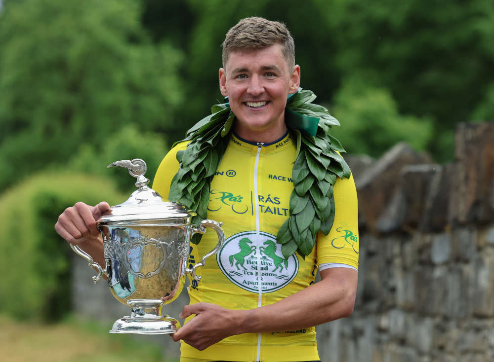 Dom Jackson (Foran CT) holds the famous George Plant Trophy outside Bective Stud after winning Rás Tailteann 2024.