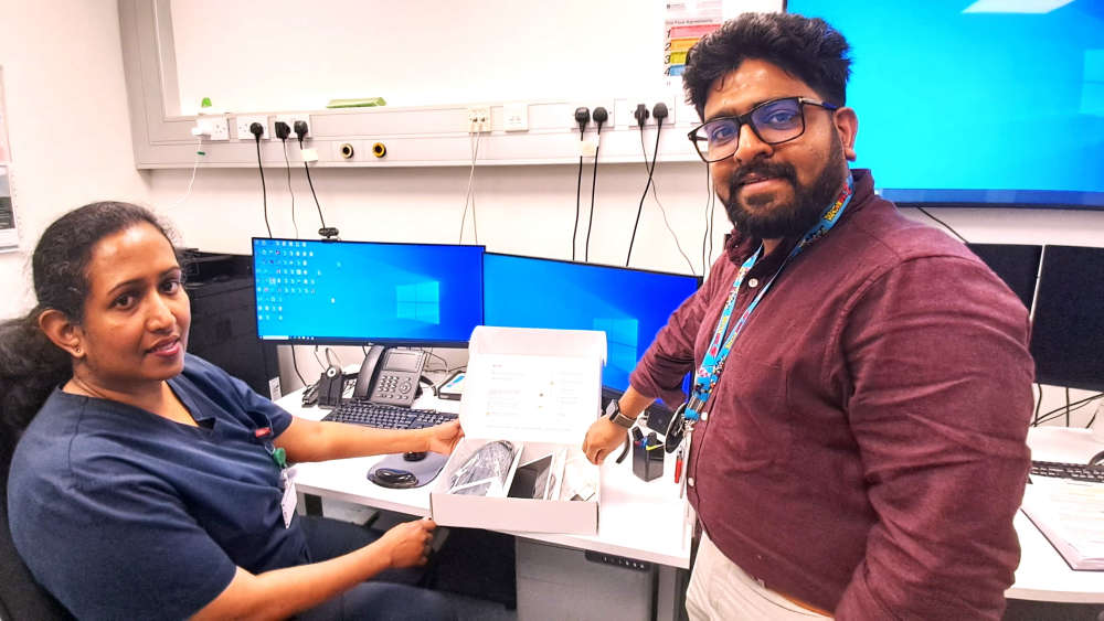 Virtual Ward Clinical Nurse Managers Jesna Jose (CNM2) and Avinash Isaac (CNM1) with the technology kit that is supplied to patients referred to the Virtual Ward