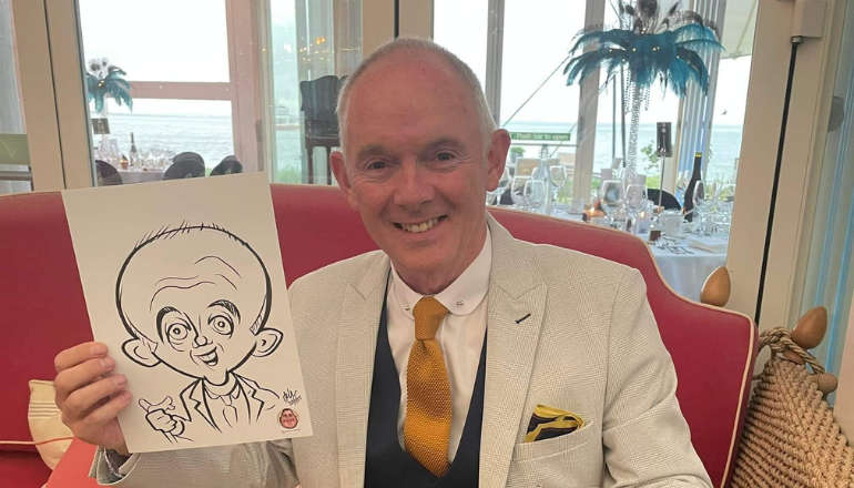 Geoff Underwood with his caricature by AdamArts