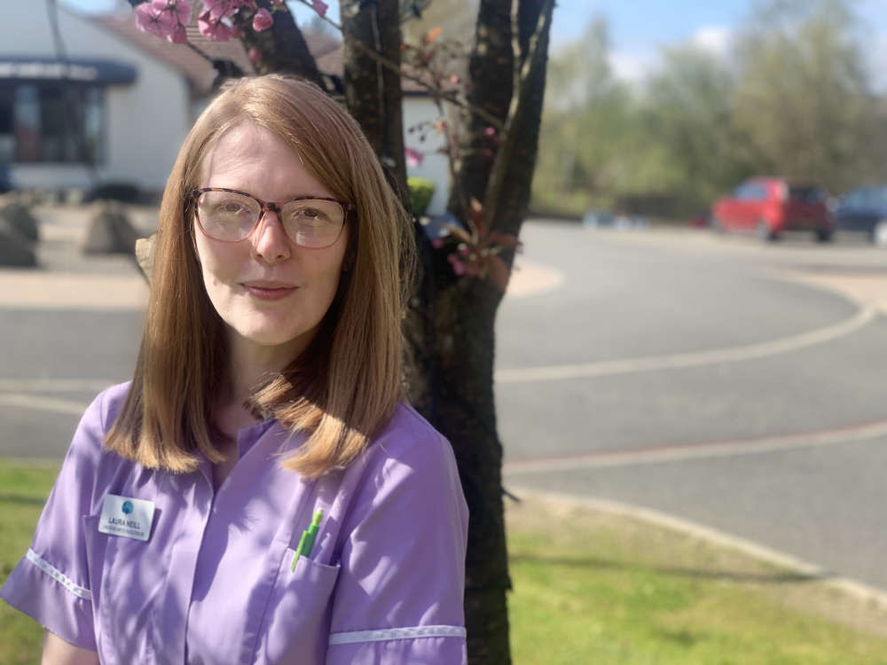 Laura Neill pictured outside Strathcarron Hospice on a sunny day with uniform on