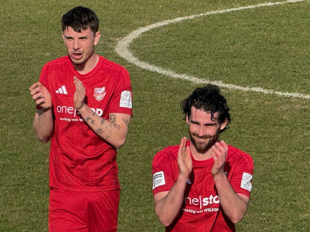 A smiling Alex Purver with Jake Hull following behind at full time
